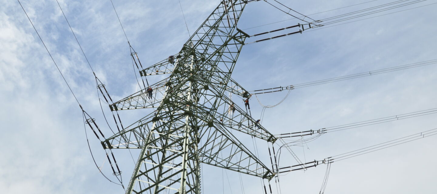Cteam technicians perform construction and maintenance on a high-voltage power transmission tower. Cteam technicians perform construction and maintenance on a high-voltage power transmission tower.