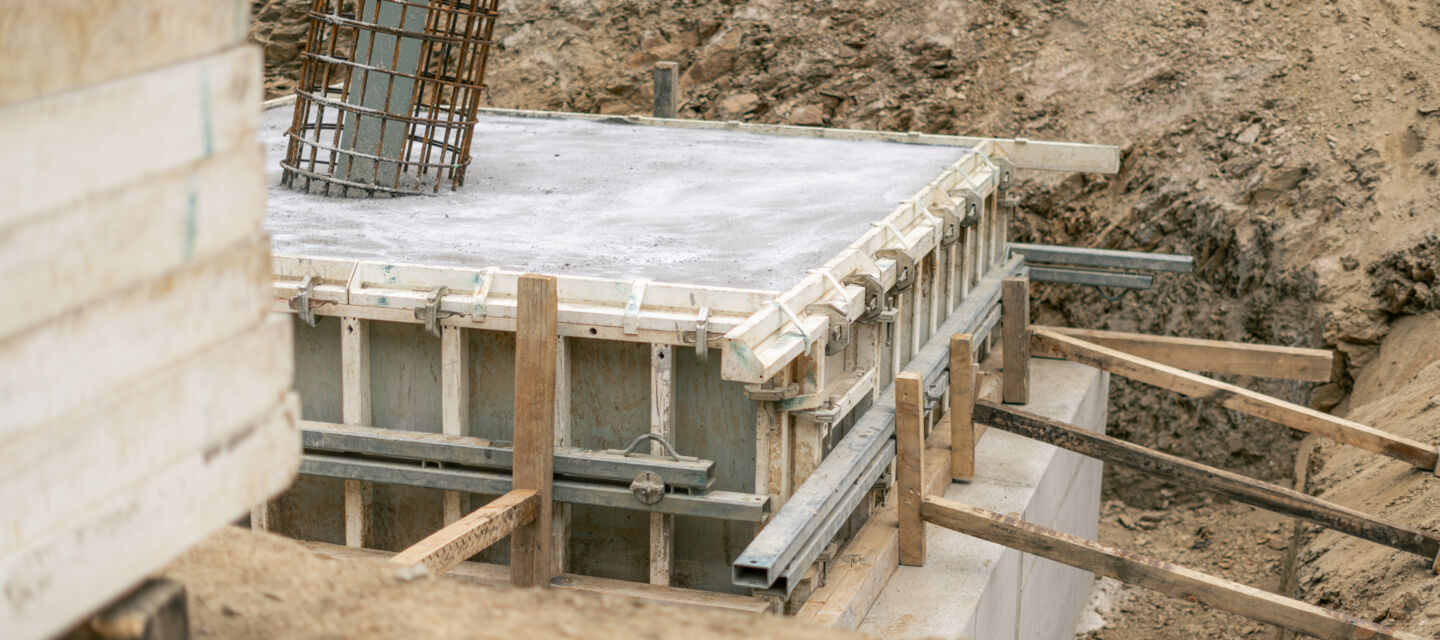 Baustellenansicht: Fundamentkonstruktion mit Schalung und Bewehrung für Cteam Infrastrukturprojekte.