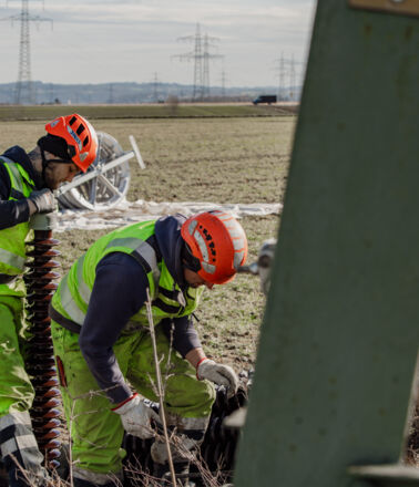 Cteam workers perform maintenance on high-voltage power line insulator. Cteam workers perform maintenance on high-voltage power line insulator.