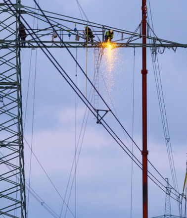 Cteam construction team working on a high-voltage pylon, ensuring reliable power infrastructure. Cteam construction team working on a high-voltage pylon, ensuring reliable power infrastructure.