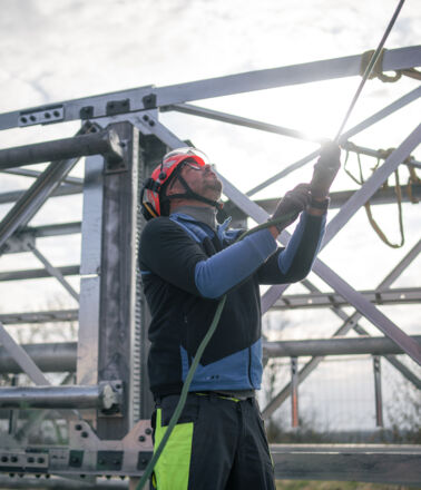 Cteam professional installing components on a high-voltage power line tower. Cteam professional installing components on a high-voltage power line tower.