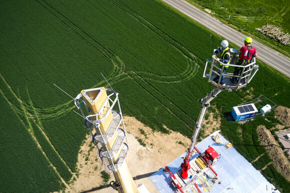 Cteam team assembling a tall wooden tower structure using a cherry picker, demonstrating infrastructure expertise. Cteam team assembling a tall wooden tower structure using a cherry picker, demonstrating infrastructure expertise.