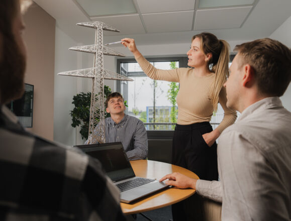 Planning new power lines: Cteam engineers review a detailed transmission tower model. Planning new power lines: Cteam engineers review a detailed transmission tower model.