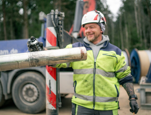 Cteam worker applying spray to a pipe during infrastructure assembly on site. Cteam worker applying spray to a pipe during infrastructure assembly on site.